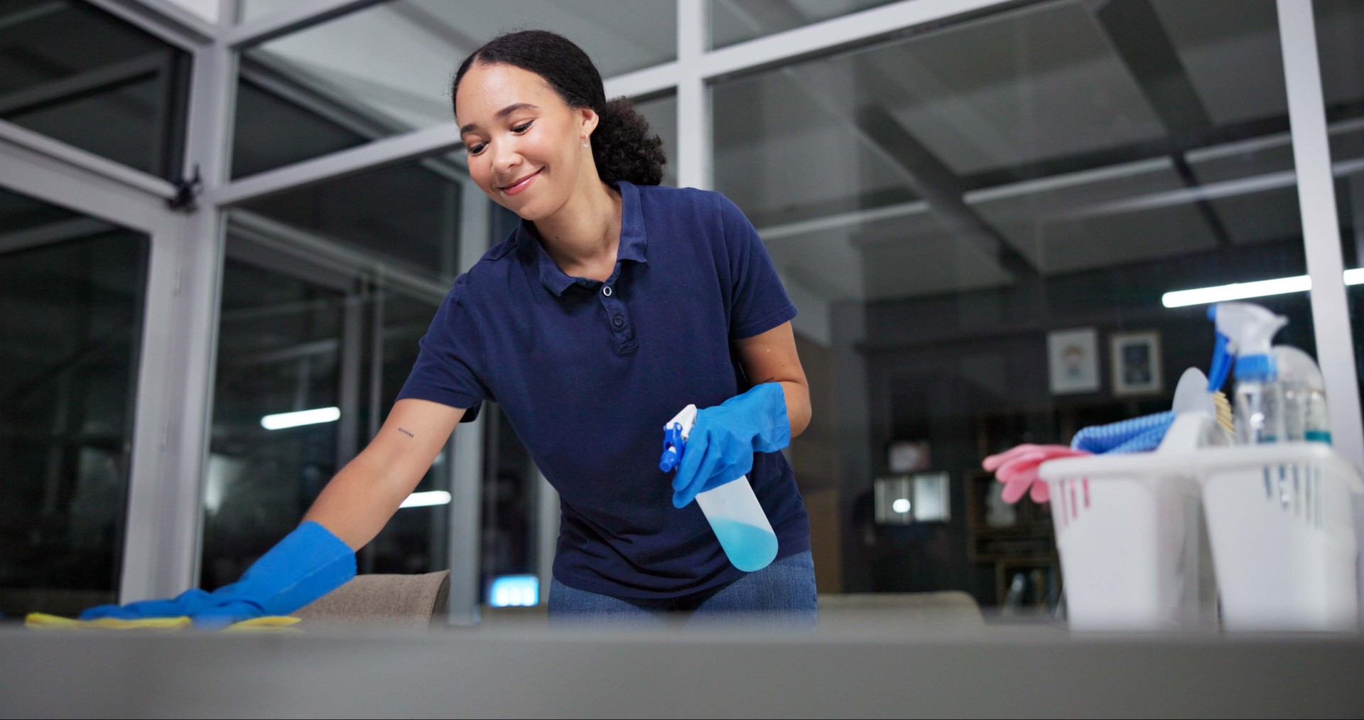 Cleaner, cleaning table woman in office from dust, spray disinfect and protection from disease risk in building. Maintenance, person and chemical liquid for pest control, health and hygiene safety Cleaner, cleaning table woman in office from dust, spray disinfect and protection from disease risk in building. Maintenance, person and chemical liquid for pest control, health and hygiene safety